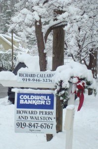 My sign decorated for the holidays and topped with snow.